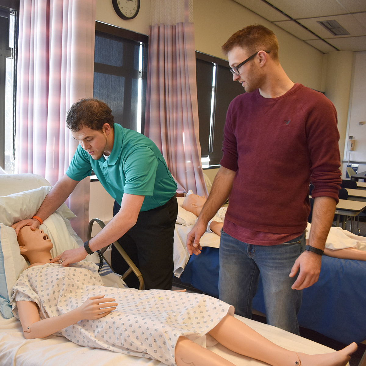 CCD Nurse Aide students practicing with a manikin
