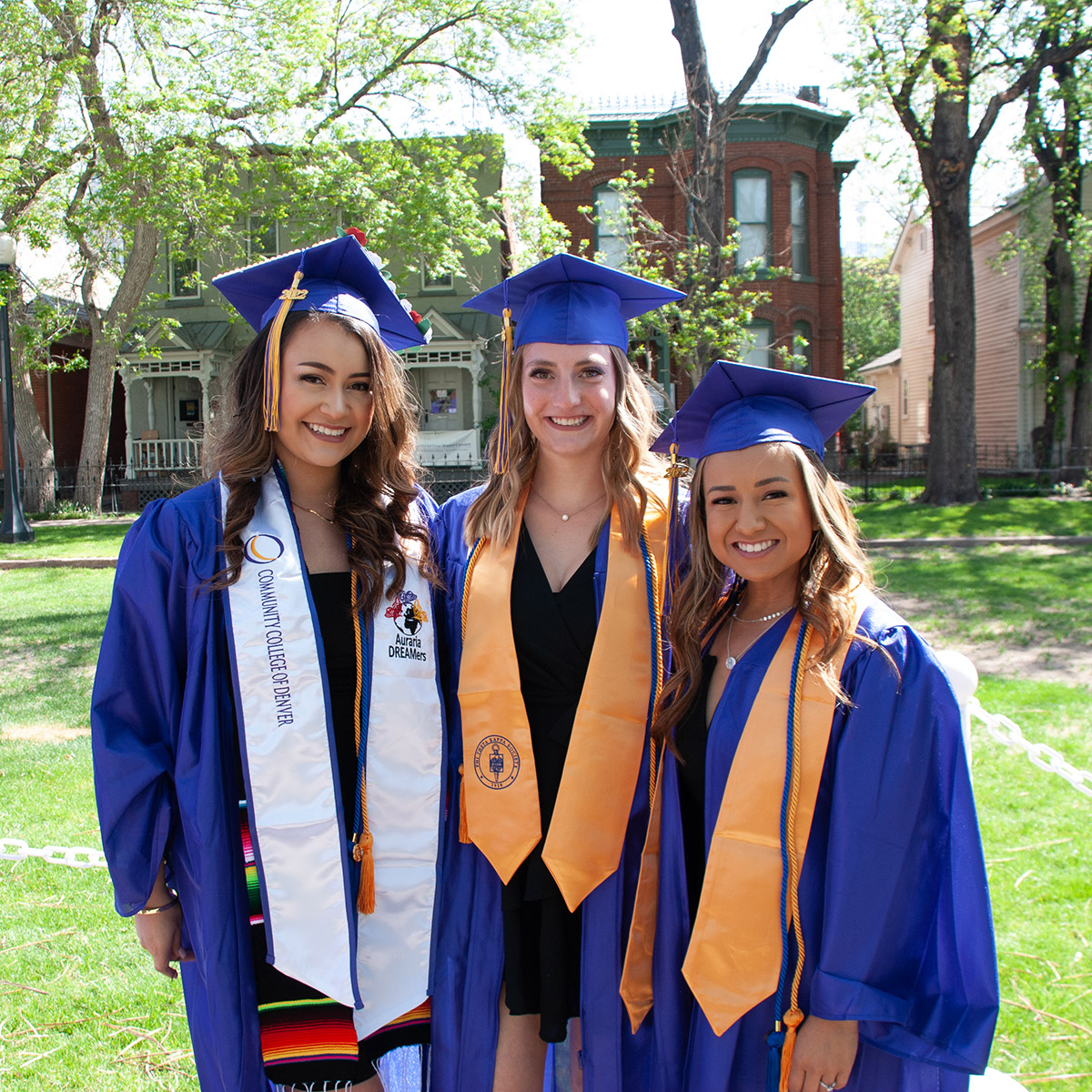 group of 3 female CCD graduates in cap and gown
