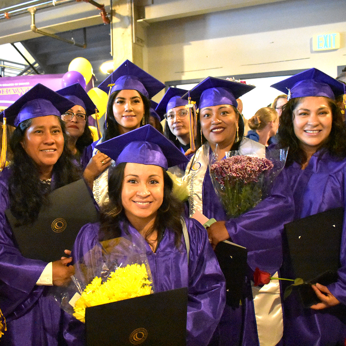 group of female CCD graduate in caps & gowns