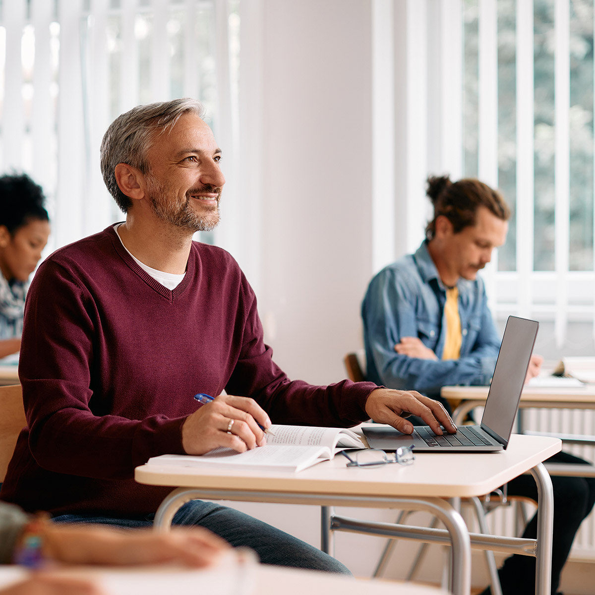 CCD High School Diploma student sitting at a desk in classroom