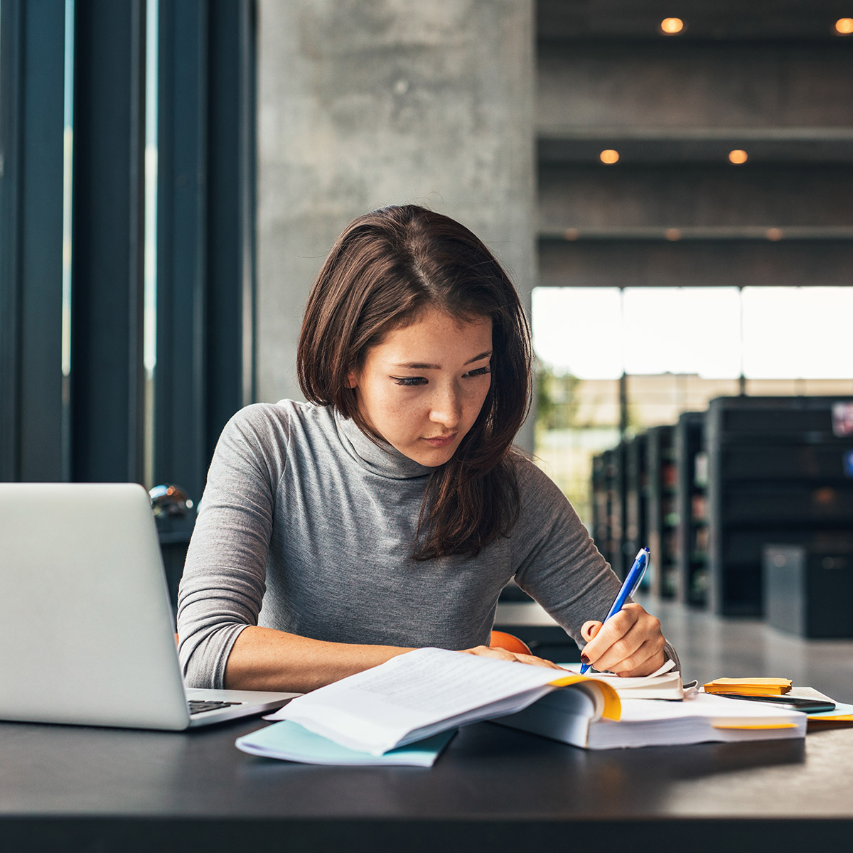 female CCD Paralegal student studying in the library