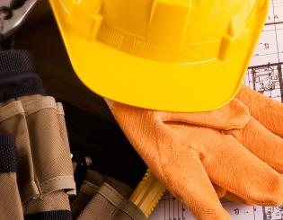 yellow hard hat, work clothes and blue prints