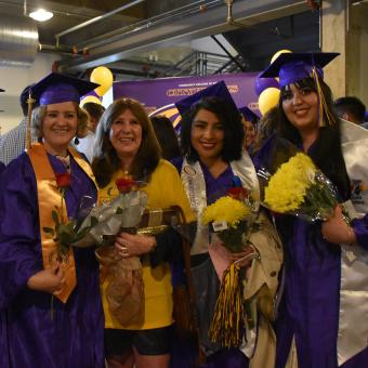 group of female CCD graduate in caps & gowns