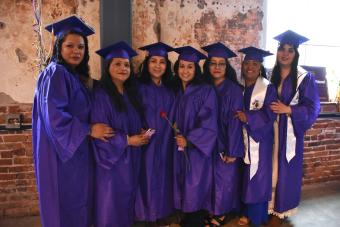 group of female CCD graduates in caps & gowns