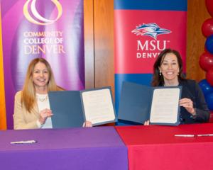 Dr. Marilena DeSanctis and Dr. Janine Davidson holding up signed documents.